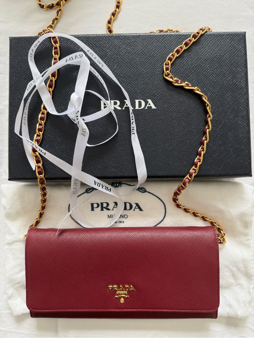 Prada Maroon Red Saffiano Leather Crossbody Wallet with Chain.